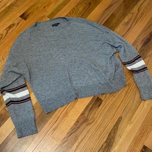 grey sweater with striped sleeve